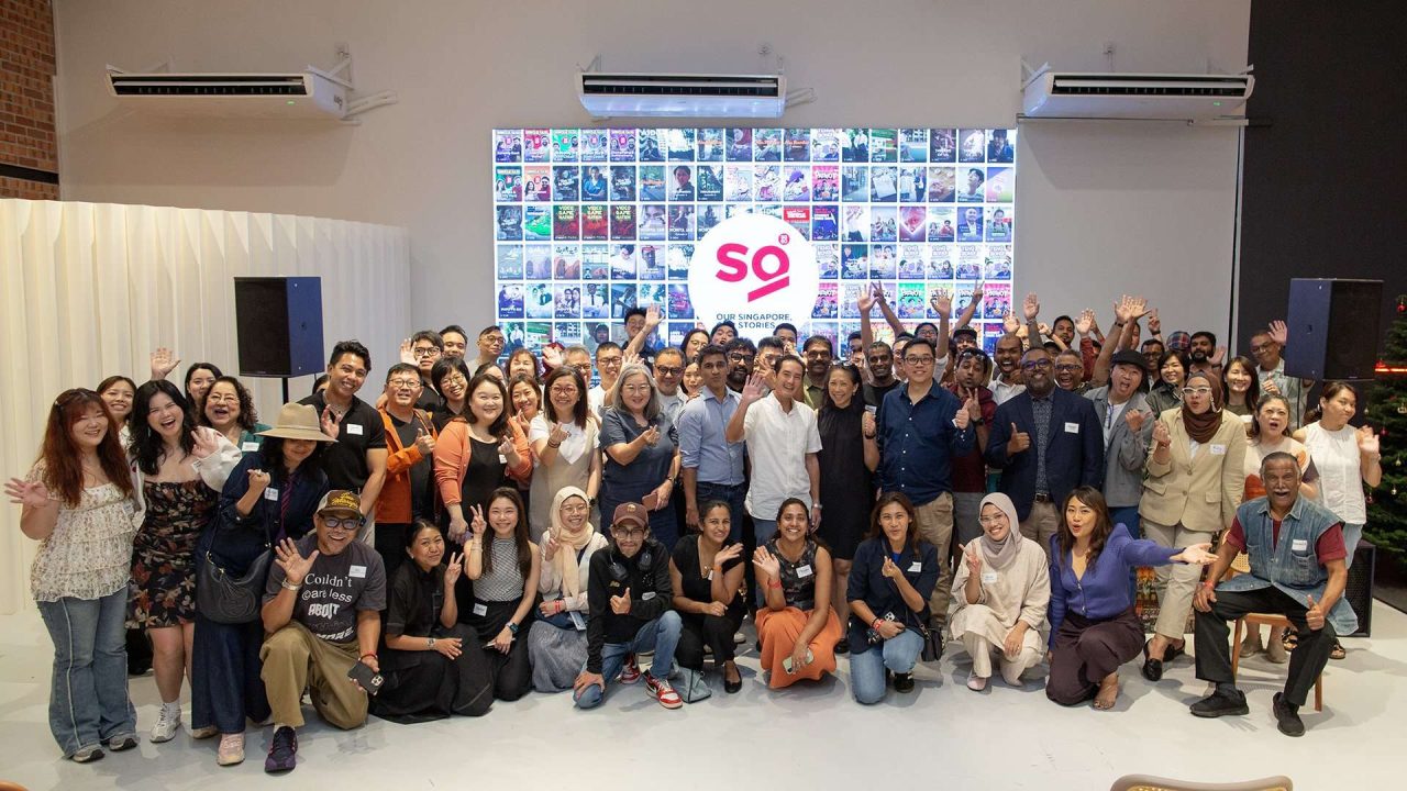 Guest of Honour, Senior Minister of State Mr Tan Kiat How (centre in white), joins creators and the Association of Independent Producers (AIPRO) to celebrate the conclusion of the "Our Singapore, Our Stories" initiative at The Southern Depot on 25 November 2025.
