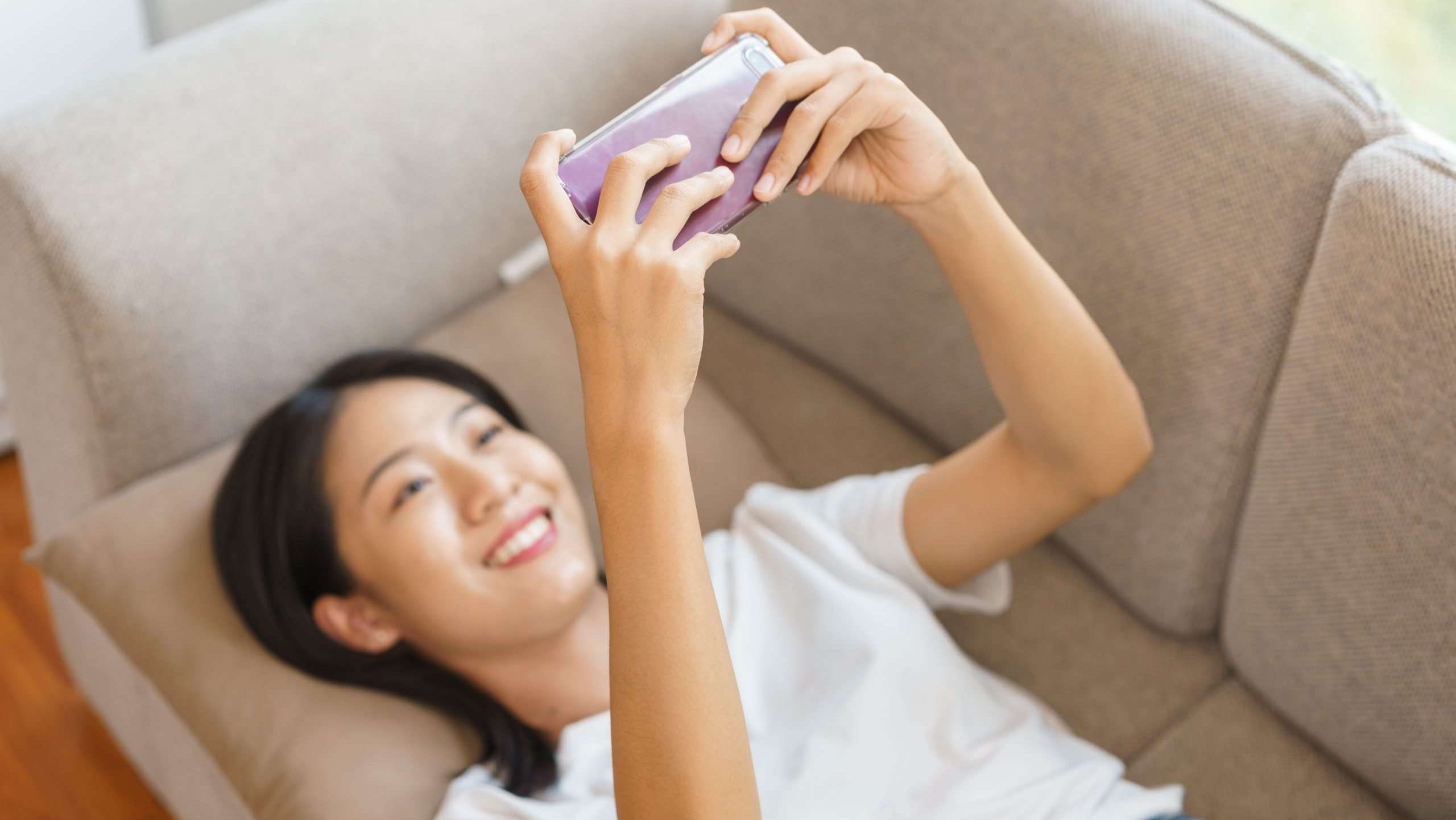 Asian Female watching content on phone